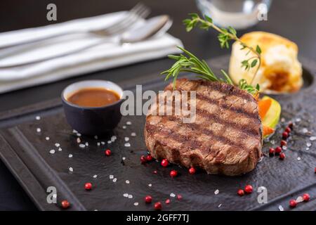 Manzo alla griglia. Bistecca di filetto su piastra di pietra con verdure grigliate. Concetto di raccordo Mignon. Foto Stock
