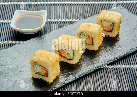 panini caldi deliziosi con salmone, formaggio spalmabile, cetriolo, caviale, masago, pangrattato e salsa piccante. Foto Stock