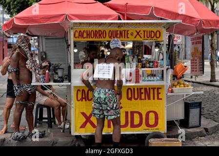 Brasile - 16 febbraio 2020: Un venditore di strada vende articoli di fast food come hot dog e hamburger durante una sfilata di Carnevale tenutasi nel centro di Rio de Janeiro Foto Stock