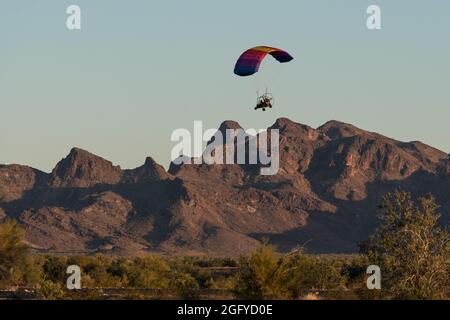 Un paracadute motorizzato o PPC vola vicino a Quartzsite, Arizona, con le montagne di Plomosa sullo sfondo. Foto Stock