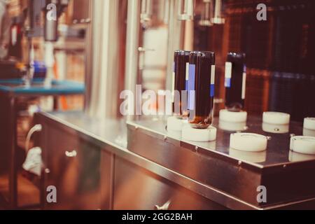 Bottiglie di vino pronte per essere lavate e riempite di vino da una macchina industriale in una cantina Foto Stock