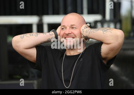 Wernigerode, Germania. 27 ago 2021. Mateo Jasik della band "Culcha Candela" si trova di fronte al palco prima del concerto all'Harz Open Air. Dopo la pioggia continua pesante un concerto della band è stato cancellato nel pomeriggio. Credit: dpa/dpa-Zentralbild/ZB/dpa/Alamy Live News Foto Stock