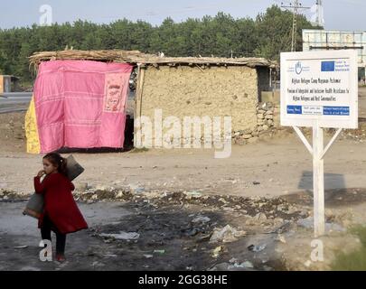 (210828) -- PESHAWAR, 28 agosto 2021 (Xinhua) -- una bambina di rifugiati afghana è vista in un campo profughi nel Peshawar del Pakistan nordoccidentale il 28 agosto 2021. Il Pakistan ospita attualmente più di 1.4 milioni di rifugiati afghani registrati che sono stati costretti a fuggire dalle loro case, secondo l'Alto Commissariato delle Nazioni Unite per i rifugiati (UNHCR). (Foto di Saeed Ahmad/Xinhua) Foto Stock