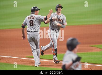 Atlanta, Georgia, Stati Uniti. 28 agosto 2021. Mike Yastrzemski, fuorilegge dei giganti di San Francisco, celebra con il suo terzo allenatore di base, mentre percorre la terza linea di base dopo aver colpito una corsa a casa durante il settimo inning di una partita MLB contro gli Atlanta Braves al Truist Park di Atlanta, GA. Austin McAfee/CSM/Alamy Live News Foto Stock