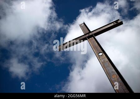 Il simbolo di ferro della religione cattolica visto nel cielo nuvoloso Foto Stock