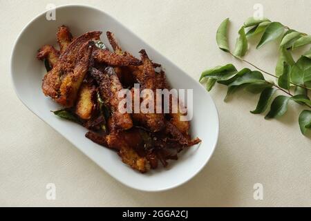 Croccante e piccante frittura di Anchovy. Acciughe marinate con spezie e fritte profonde. Piatto di pesce popolare dal Kerala chiamato Natholi fry. Foto Stock