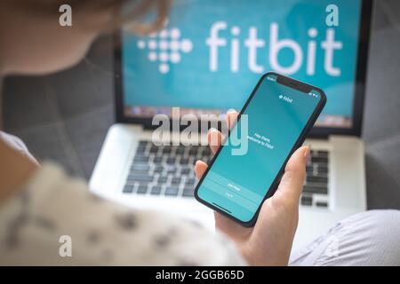 Kharkov, Ucraina - 25 agosto 2021: Donna che usa l'applicazione Fitbit e tiene smartphone, immagine di stock Foto Stock