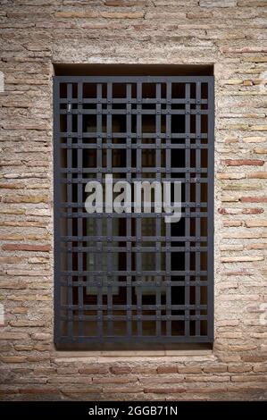 dettaglio di una vecchia griglia su una finestra in un vecchio muro di mattoni Foto Stock