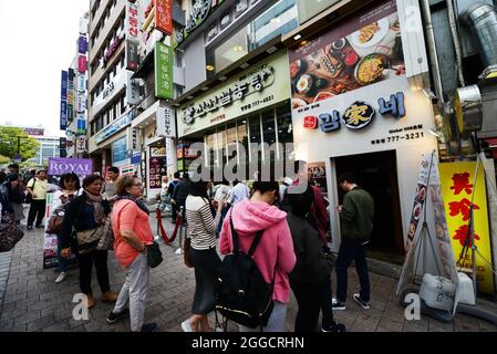 I visitatori che fanno la fila fuori dal ristorante SINSEON Seolongtang nel quartiere dello shopping di Myeongdong a Seoul, Corea del Sud. Foto Stock