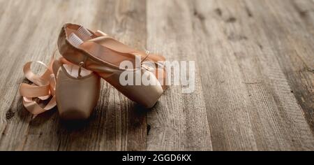 Scarpe Pointe con nastri su fondo di legno Foto Stock