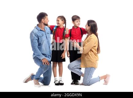 Bambini piccoli con i loro genitori su sfondo bianco Foto Stock