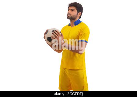 UN GIOCATORE DI CALCIO CHE GUARDA SOPRA MENTRE SI PRATICA Foto Stock