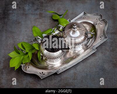 Composizione di more fresche in supporto per creamer argentato d'annata. Foto Stock