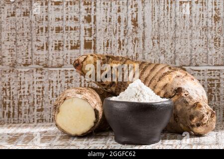 Radice di Taro dell'esculenta della colocasia e farina di Taro organica in una ciotola Foto Stock