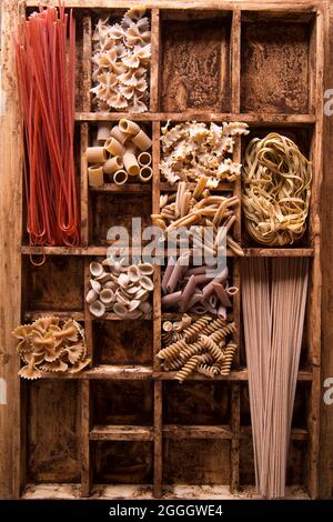 Presentazione di un mix di pasta diversa integrale stivata in piccoli contenitori Foto Stock