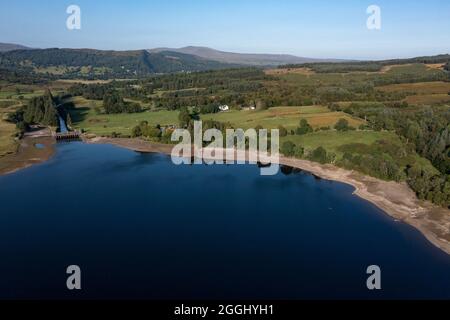 Loch Venachar, Scozia, 26 agosto 2021. Nella foto: Vista aerea che guarda dall'alto, con un drone che mostra Loch Venachar con i suoi livelli d'acqua più bassi negli anni a causa della siccità, come le condizioni meteorologiche durante la lunga estate calda e secca in Scozia. Questo ha causato il lago di restringersi ed esporre grandi palpate di spiagge di ghiaia costringendo le persone che vogliono usare il lago di camminare in alcuni casi un extra quaranta metri al bordo delle acque. Credit: Colin Fisher/Alamy Live News. Foto Stock