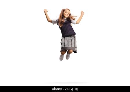Ragazza felice in un salto uniforme isolato su sfondo bianco Foto Stock