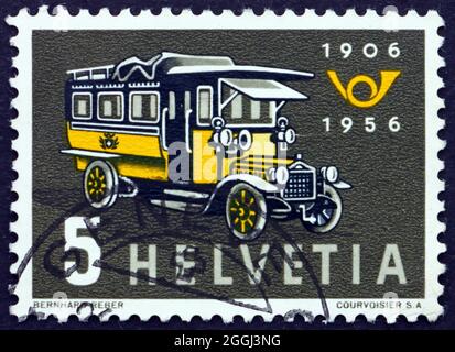 SVIZZERA - CIRCA 1956: Un francobollo stampato in Svizzera mostra il primo Swiss Post Bus, 50° anniversario della Swiss Motor Coach Service, circa 1956 Foto Stock