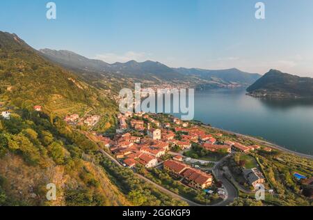 Bellissima vista panoramica aerea dal drone al lago d'Iseo e al suo paese, Lombardia, Italia Foto Stock