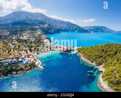 Vista aerea panoramica del pittoresco villaggio di pescatori di Assos, Cefalonia, Grecia, Viaggi barche a vela ormeggiate sul mare turchese Foto Stock