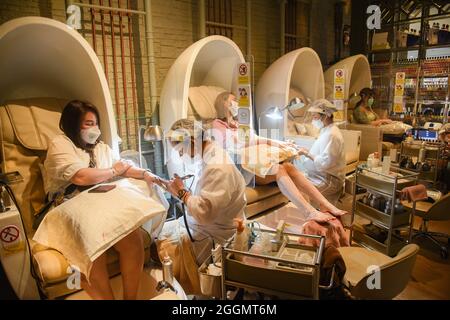 Nonthaburi, Tailandia. 01 Settembre 2021. I clienti che hanno manicure e pedicure in un salone come il governo thailandese solleva parzialmente il blocco consentendo ad alcune aziende di riaprire seguendo termini e condizioni come sociale distanziamento e indossare maschere protettive. (Foto di Yuttachai Kongprasert/SOPA IMA/Sipa USA) Credit: Sipa USA/Alamy Live News Foto Stock