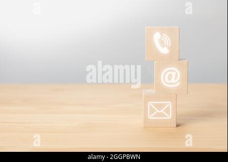 contattaci icona telefono, e-mail, posta su legno cubo, servizio clienti e assistenza. Cubi di legno con simbolo telefono, e-mail, indirizzo. Pagina web contac Foto Stock