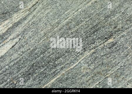 La texture del marmo. Sfondo di pietra. Inclusioni bianche in pietra naturale riprese in dettaglio. Foto Stock