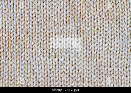 Sfondo beige lavorato a maglia. Primo piano Foto Stock