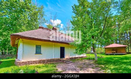 La facciata della tradizionale casa ucraina imbiancata, sormontata da tetto di paglia, Pereiaslav Scansen, Ucraina Foto Stock