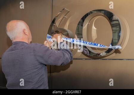 Londra, Regno Unito. 3 settembre 2021. Nastro per la scena del crimine climatico fuori dagli uffici di BlackRock Investment Management. Un attivista della ribellione per l'estinzione affida un nastro blu e bianco sulla "SCENA DEL CRIMINE CLIMATICO" su un grande "60" metallico durante una protesta a Londra. L'azione accusa simbolicamente gli istituti finanziari di contribuire alla disgregazione del clima e alle inondazioni attraverso investimenti in combustibili fossili. Il numero può fare riferimento a un traguardo aziendale o a un obiettivo finanziario. La protesta evidenzia il legame tra i sistemi monetari e il degrado ambientale. Penelope Barritt/Alamy Live News Foto Stock