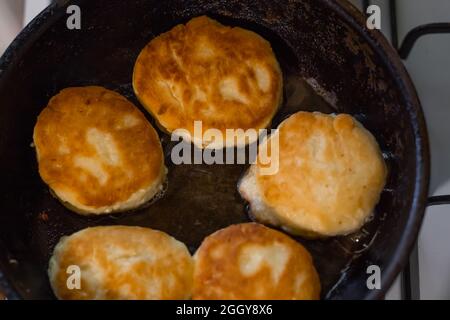 A colazione vengono preparati pancake appena fritti. Cucina cibo in cucina. Foto Stock