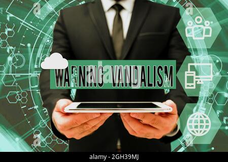 Cartello con scritto Warning vandalism, Conceptual photo malware defacement of public or private property Man in Office Uniform Holding Tablet Displayi Foto Stock