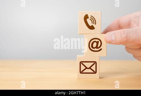 Mettere mano legno cubo simbolo telefono, e-mail, indirizzo. Marketing concetto. Contattaci e call center servizio clienti concetto, icona mobile p Foto Stock