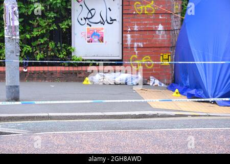 Manchester, Regno Unito, 6 settembre 2021. La polizia ha indonato l'incrocio tra Oxford Road e Devas Street e gli ufficiali legali stanno indagando intorno a una tenda di polizia, con ufficiali in uniforme che sorvegliano la scena. I marcatori di evidenza sono a terra. La polizia di Greater Manchester ha dichiarato: "Questo incidente ha portato un uomo a subire gravi lesioni alla testa". Credit: Terry Waller/Alamy Live News Foto Stock