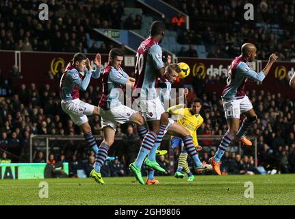 Nathan Baker di Aston Villa è stato colpito in testa da un colpo di Serge Gnabry di Arsenal e si è allargato durante la partita della Barclays Premier League tra Aston Villa e Arsenal al Villa Park di Birmingham, Inghilterra, il 13 gennaio 2014. Foto Stock