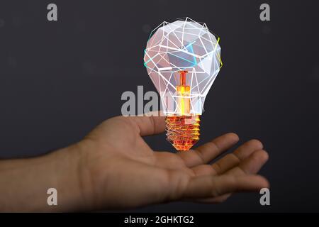 Lampadina 3D renderizzata futuristica che si sovrappone alla mano di un uomo su uno sfondo nero Foto Stock