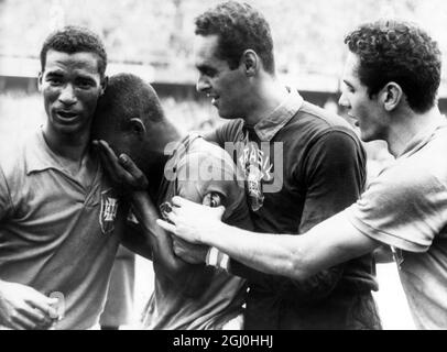 1958 Coppa del mondo Brasile / Svezia Pele di diciassette anni si zena sulla spalla del compagno di squadra Didi come Garrincha e Orlando (a destra) lo confortano, dopo che il Brasile aveva battuto la Svezia 5-2 nella finale della Coppa del mondo. 1 luglio 1958. Foto Stock