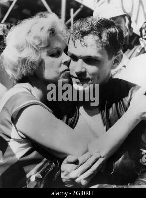 Gary Hocking di Rhodesia ottiene un abbraccio di vittoria nel paddock dopo aver vinto l'evento Senior TT sull'Isola di Man su una MV Agusta 500cc con una velocità record di 103.51 mph. 8 giugno 1962 Foto Stock