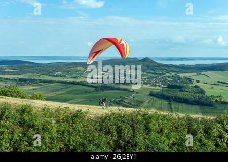 Parapendio sulle montagne del lago Balaton in Ungheria in una giornata estiva. Foto Stock