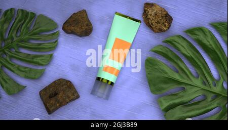Tubo di crema con foglie e pietre di monstera Foto Stock
