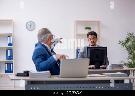 Due dipendenti di sesso maschile che lavorano in ufficio Foto Stock