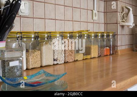 Legumi ordinati in vasi sul contatore della cucina fuoco selettivo Foto Stock