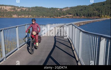 Tour dei ciclisti con eMTBs sul sentiero lungo 72 miglia del Coeur d'Alenes da Plummer a Mullan Idaho. (SIG.) Foto Stock