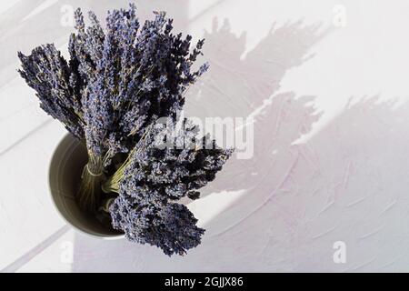 Lavanda asciutta in mazzi su sfondo bianco da vicino. Raccolta di fragranti fiori estivi. Preparazione pre-vendita. Il concetto di aromaterapia, cosmet Foto Stock