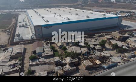 Tijuana, Messico. 4 settembre 2021. Il nuovo magazzino di Amazon è circondato da un muro accanto a un quartiere più povero. Credit: Stringer/dpa/Alamy Live News Foto Stock