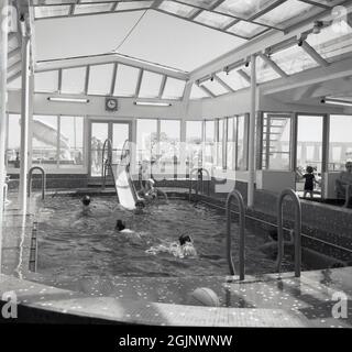 1965, storico, passeggeri della nave da crociera godendo la piscina coperta sul mare di Sagafjord. Costruita per la Norwegian America Line e uno dei rivestimenti più lussuosi del suo tempo, la costruzione della nave da crociera era così costosa che ha messo fuori dal commercio il cantiere che l'ha costruita, la società francese di lunga data di FCM. Il suo primo viaggio è stato da Oslo a New York nell'ottobre 1965 e ha stabilito un nuovo punto di riferimento per il lusso in mare. La nave è stata votata tra le 10 migliori navi da crociera al mondo fino ai primi anni '90. Foto Stock