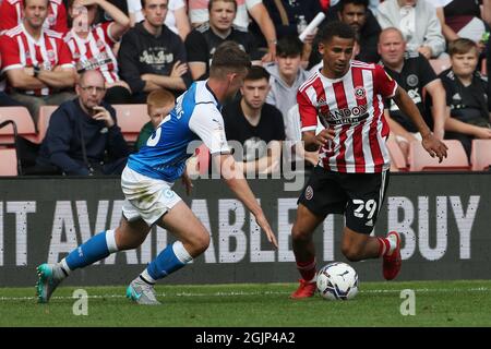 Sheffield, Inghilterra, 11 settembre 2021. Iliman Ndiaye of Sheffield Utd e Harrison Burrows of Peterborough United durante la partita del campionato Sky Bet a Bramall Lane, Sheffield. Il credito dovrebbe essere: Alistair Langham / Sportimage Foto Stock