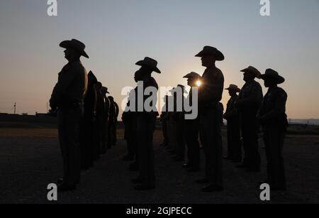 Alpine, Stati Uniti. 11 Settembre 2021. La pattuglia di confine degli Stati Uniti e le forze dell'ordine locali stanno all'alba in ricordo del 20° anniversario degli attacchi terroristici del 9/11 alla stazione di pattuglia di confine alpina 11 settembre 2021 ad Alpine, Texas. L'evento commemora le quasi 3,000 persone uccise dai terroristi l'11 settembre 2001. Credit: Greg L. Davis/CBP Photo/Alamy Live News Foto Stock