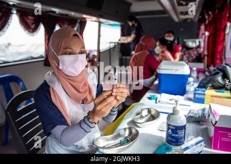 Kuala Lumpur, Malesia. 12 settembre 2021. Un operatore medico prepara una dose di vaccino COVID-19 in Klang di Selongor, Malesia, 12 settembre 2021. La Malesia ha registrato un nuovo picco di 592 morti in un solo giorno da COVID-19 a mezzanotte di sabato, portando il totale dei decessi a 20,419, secondo il ministero della salute. Credit: Chong Voon Chung/Xinhua/Alamy Live News Foto Stock