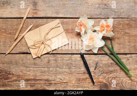 Busta con testo LAVANDA LAVANDULA, penne e fiori su sfondo di legno Foto Stock